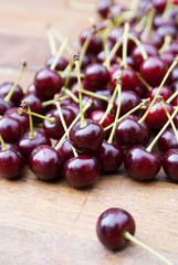 Ripe fresh berries of a cherry on an old wooden table