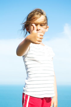 girl shows a hand sign