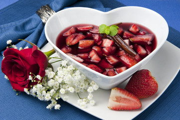 strawberries with red wine, cinnamon and brown sugar on a colore
