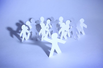 A group  paper people holding hands indicating community support