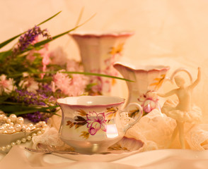 Vintage tea in elegant cups and flowers