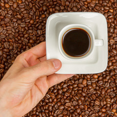 Cup of coffee on beans. top view