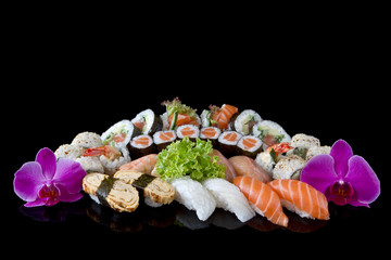variey od sushi over black background