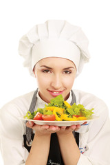 Pretty cook chief holding salad