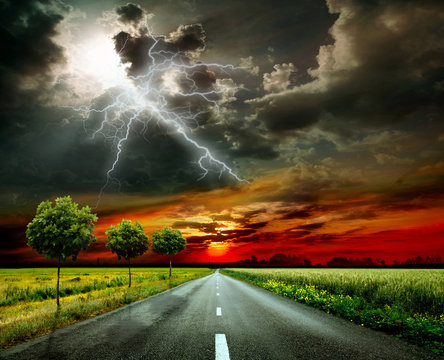 Asphalt road and lightning