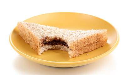Bitten sandwich with chocolate on plate isolated on white