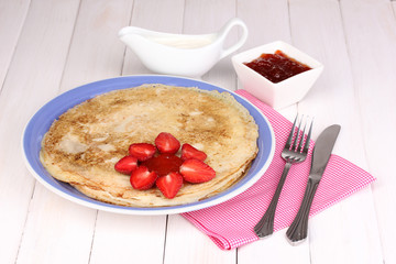 Stack of tasty pancakes on wooden background