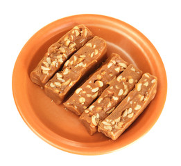 Cut east sweets - sherbet with nuts in the plate isolated