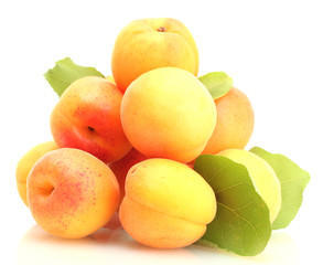 Naklejka na ściany i meble ripe apricots with green leaves isolated on white