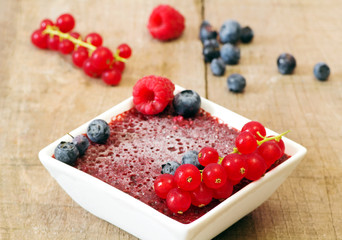 ice-cream dessert with berries over wood