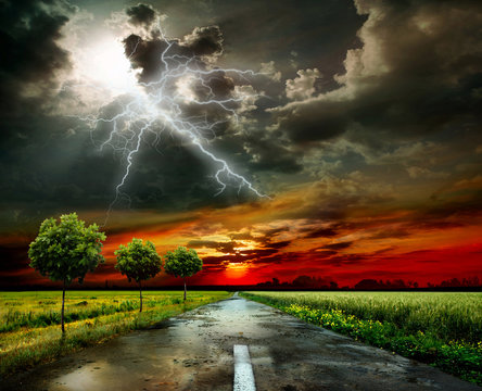 Asphalt road and lightning