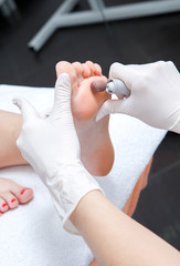 Peeling feet pedicure procedure in a beauty salon