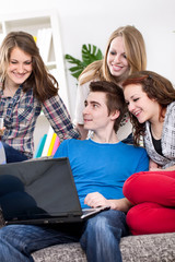 Group of teenagers watching looks funny clip online