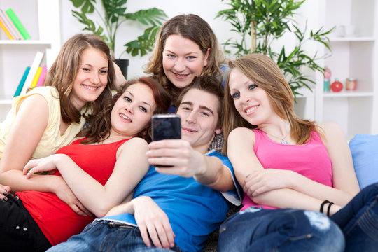 Friends taking a picture of themselves on cell phone