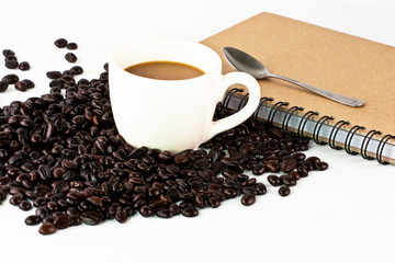 Cup with offee grain,Spoon on notebook paper