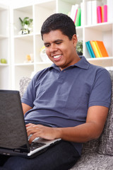 Young man typing on laptop