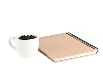 paper notebook front cover and offee feed in cap