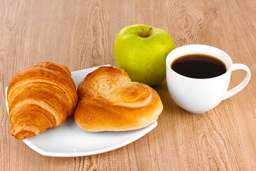 Classical breakfast. Coffee with croissant and bun