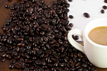 white cup of coffee with beans