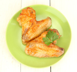 roasted chicken wings with parsley in the plate