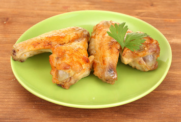 roasted chicken wings with parsley in the plate