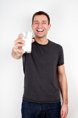 Young man smiling with glass of milk