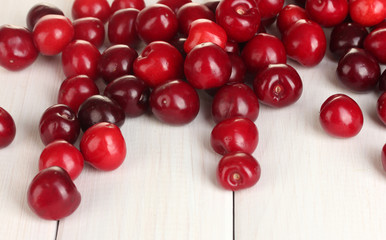 fresh cherry on white wooden table close-up