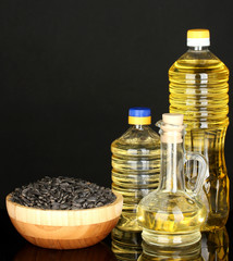 sunflower oil in bottles isolated on black background