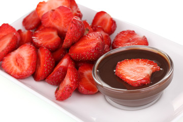 Fresh strawberries on plate with chocolate close-up