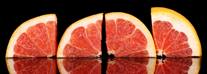 Sliced grapefruit isolated on black