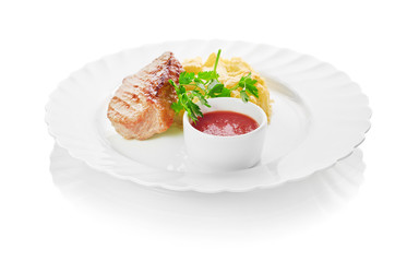 Grilled meat with trimmings isolated on a white background