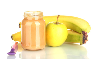 Jar with fruit and baby food and spoon isolated on white