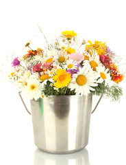 beautiful bouquet of bright  wildflowers in metal bucket,
