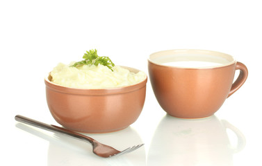 Mashed potato with parsley in the bowl and cup with milk