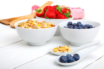 fresh blueberry, strawberry and corn flakes in white porcelain