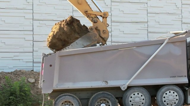 Excavator loading dump truck