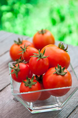 Freshly harvested summer cherry tomatoes on wooden background