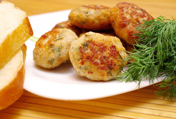 burgers on a plate with dill and bread