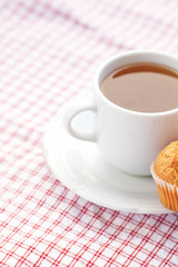 bar of chocolate and muffin on plaid fabric