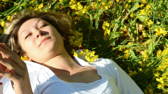Pretty girl and boy in a rape field, view from above