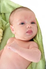 Portrait of cute newborn baby girl on a white background