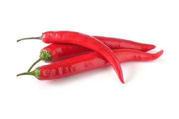 three red chili peppers isolated on white