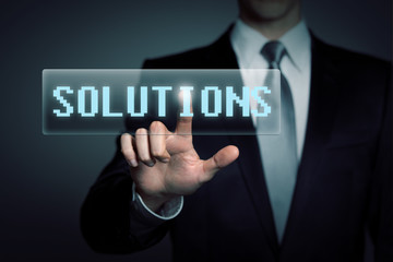 businessman pressing virtual solutions button