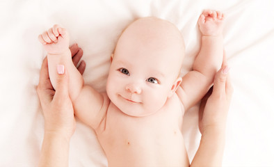 Mother massaging  baby