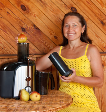 Woman Makes  Pear Juice Using Juicer