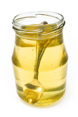 Honey in jar with silver spoon