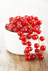 redcurrants in bowl on wooden