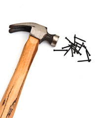 hand hammer with pile of  nails over white
