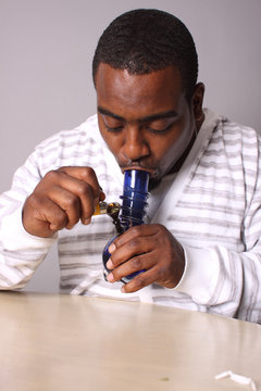 Medical marijuana user with a water pipe.