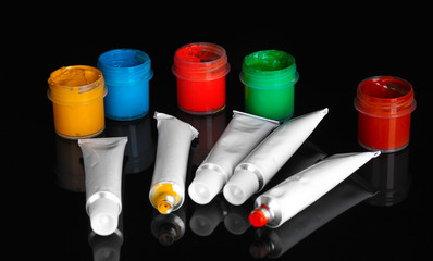 Tubes with colorful watercolors and jars with gouache isolated